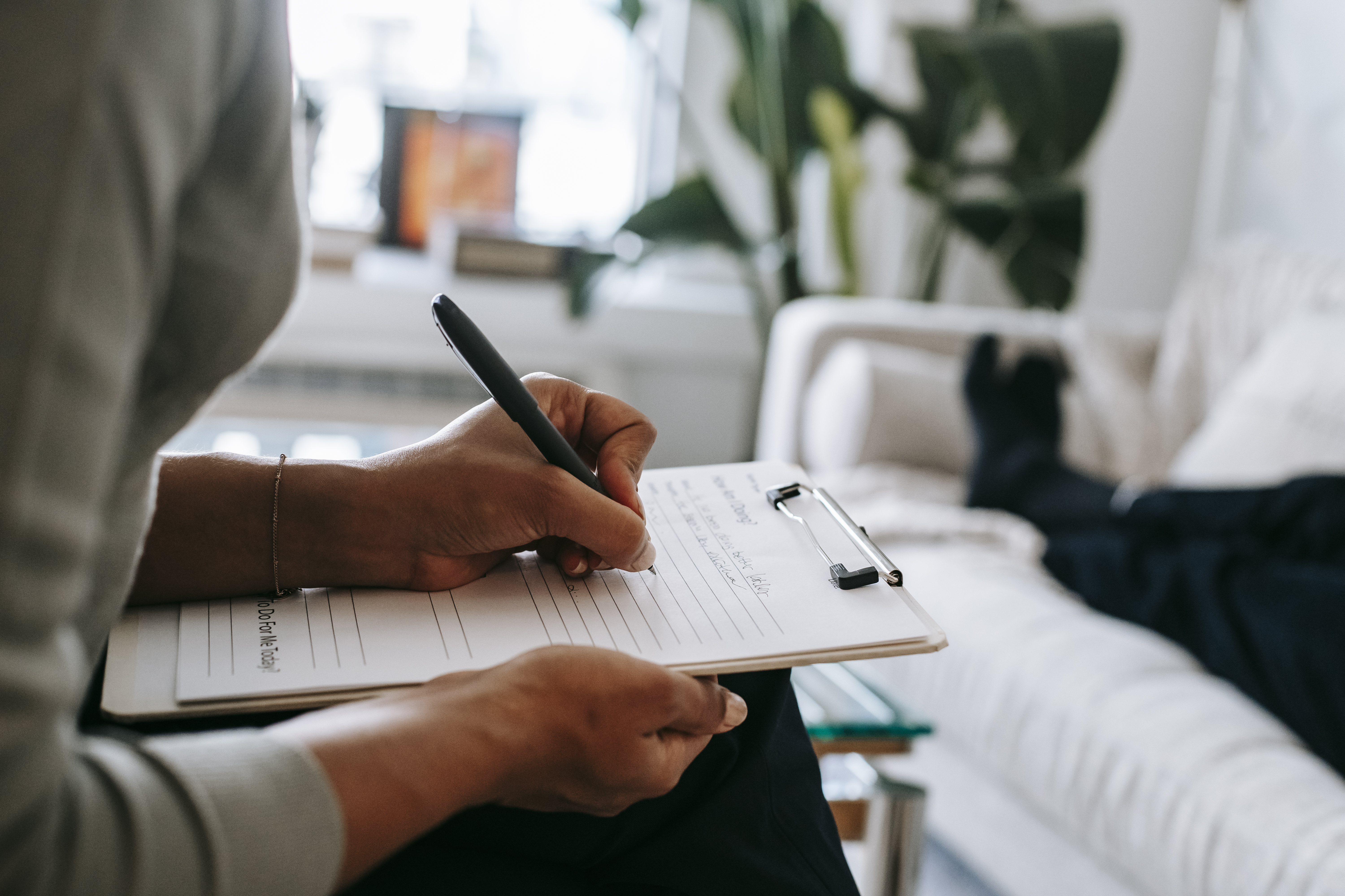 An image featuring a man holding a writing pad or notebook